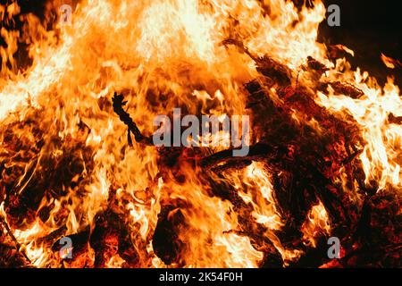 A Fire embers particles over black background. Fire sparks background. Abstract dark glitter fire particles lights. bonfire in motion blur. Stock Photo