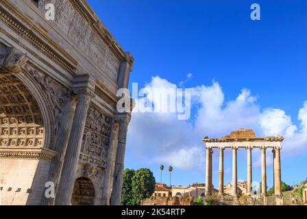 The Imperial Fora in Rome, Italy. View of the triumphal arch of Septimius Severus to the side and in the background the Temple of Saturn. Stock Photo