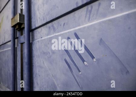 Dirty metallic wall detail with traces of a hand Stock Photo