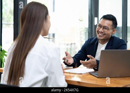 lawyer insurance broker consulting giving legal advice to couple customer about buying renting house. financial advisor with mortgage loan investment Stock Photo