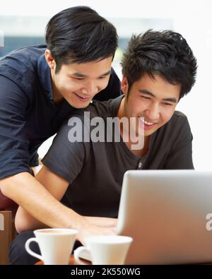 What about this one. a young gay couple using a laptop indoors. Stock Photo