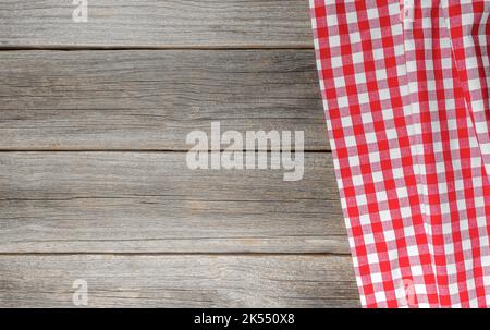 Checkered tablecloth on a wooden background. Stock Photo
