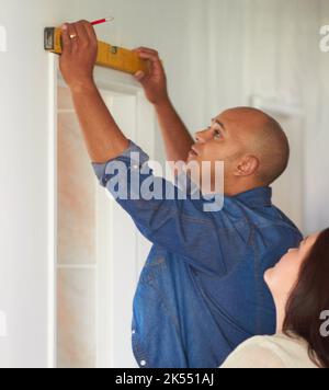 My measurements are spot on. a womans husband making measurements with a spirit level. Stock Photo