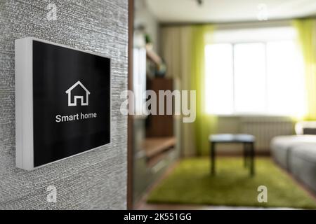 Wireless technology for managing smart devices at home concept. check security and external video surveillance, select program on touch screen panel w Stock Photo