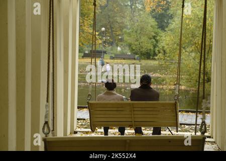 Romantic couple swing in the autumn park Stock Photo - Alamy