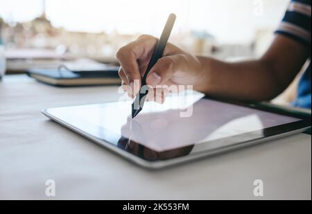 Digital tablet, designer hands writing with pen for design planning, creative animation or advertising project on desk in studio. Tech, notepad or web Stock Photo