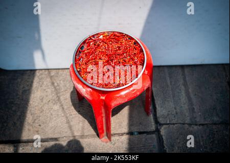 Red chillies laid out to dry in a central Bangkok market place, Thailand. Stock Photo