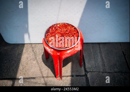 Red chillies laid out to dry in a central Bangkok market place, Thailand. Stock Photo