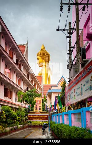 The giant golden Buddha looms large above the city of Bangkok Thailand at Wat Paknam. Temple full name; Wat Pak Nam Phasi Cheroen. Stock Photo