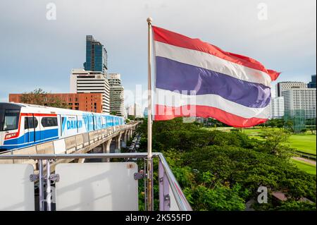 The Thailand flag flies on the platform of the BTS mass transit sky train station of Ratchadamri, Bangkok, Thailand. Stock Photo