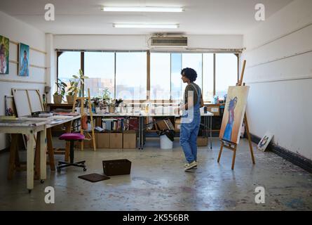 Canvas, woman artist and girl painter with painting for exhibition in studio, art gallery and workplace. Lady, female and creative in workshop with Stock Photo