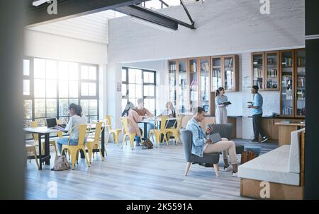 Library, education and students study in university campus, college or school. Learning, diversity and people relax with books, laptop or phones Stock Photo