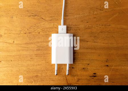 Smartphone charger path isolated on wooden background Stock Photo