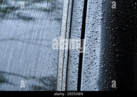 Water droplets on the surface of the car body after rain Stock Photo