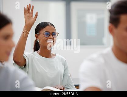 Learning, education and student with question in class lift up a hand to answer at school, college and university. Scholarship woman sitting at a Stock Photo