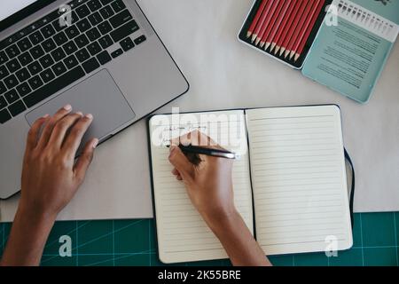 Art, planning and hands writing about exhibition, research on gallery for painting and notes for schedule at desk. Artist, designer or receptionist Stock Photo