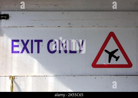 Exit only sign and red triangle warning sign of aircraft Stock Photo