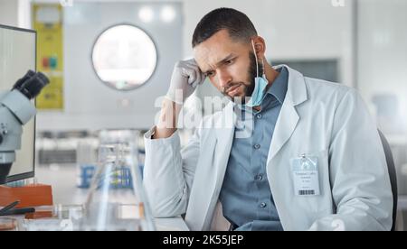 Science, research and covid with a confused man engineer working on innovation in his laboratory. Thinking, analytics and development with a male Stock Photo