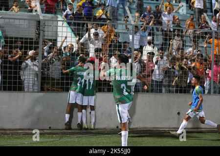 Delighted Bangladesh Under-17 players run towards the crowd at the Birshrestha Shaheed Mostafa Kamal Stadium after a spill from Singapore goalkeeper I Stock Photo