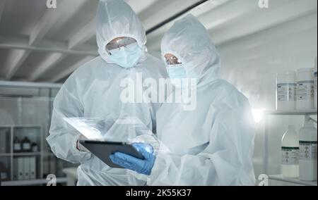 Covid, science and tablet with an engineer and technician working as a team on research on innovation in a lab. Teamwork, technology and analytics Stock Photo