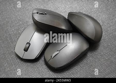 four different wireless mice on a black background Stock Photo