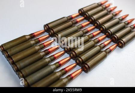 Ammunition for automatic rifle lined up with groups on a white background stock photo Stock Photo