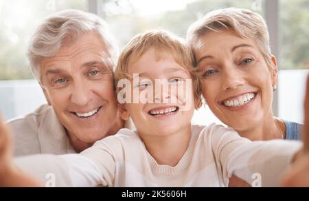 Grandparents, selfie and happy family portrait in living room by smiling, caring family bond in their home together. Love, relax and cheerful elderly Stock Photo