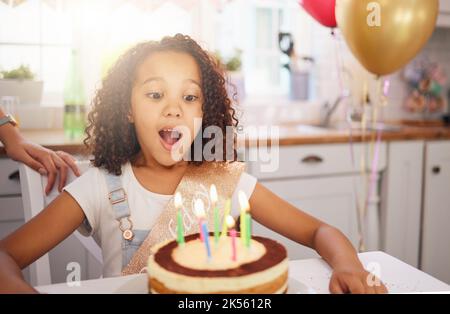 Happy birthday cake, candles and child with surprise, excited and happy face for love, care and celebration. Party, balloons and celebrate with black Stock Photo