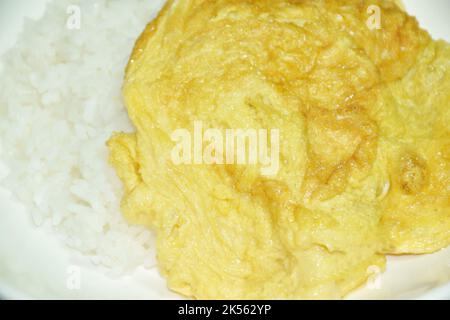 crispy Thai egg omelet topping on plain rice Stock Photo