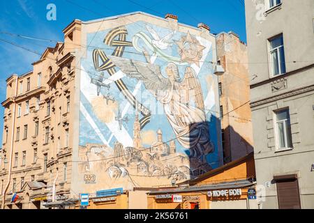 Saint Petersburg, Russia - 04.01.2022: Huge drawing at end of building. Woman angel over St. Petersburg city, victory day in second world war. Stock Photo