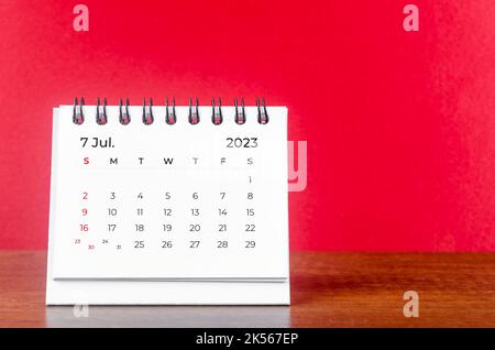 July 2023 desk calendar for 2023 year on Red color background. Stock Photo