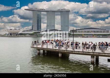 Marina Bay Sands, ArtScience Museum far left, Tourists on Viewing Platform in foreground.  Singapore. Stock Photo