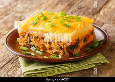 casserole of mashed potatoes with minced meat and vegetables on top with cheese close-up on a plate on the table. horizontal Stock Photo