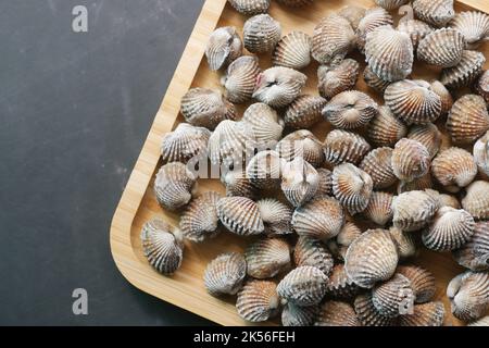 top view of cockles on a plate on black background  Stock Photo