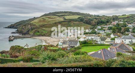 A wide panoramic view from above Gorran Haven at the beginning of autumn colour, a small Cornish village, beach and harbour in Cornwall, England. Stock Photo