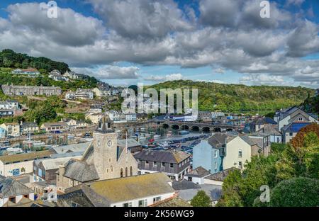 A colourful scenic view taken from above the town of East Looe, Cornwall. Looking down from Barbican Hill towards the Old Bridge across the estuary. Stock Photo