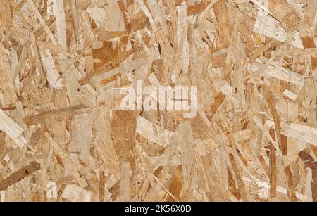 Oriented strand board background, closeup directly above view. Engineered wood used in construction typically for sheathing and load bearing projects. Stock Photo