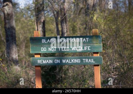 POVERTY POINT RESERVOIR STATE PARK, DELHI, LOUISIANA/USA – MARCH 05 2020: Green sign marking the Black Bear Habitat and warning hikers to remain on th Stock Photo