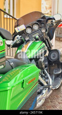 old retro motorcycle traveling through city streets Stock Photo