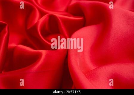Satin vs silk textures, red fabric quality comparison, soft focus close up Stock Photo