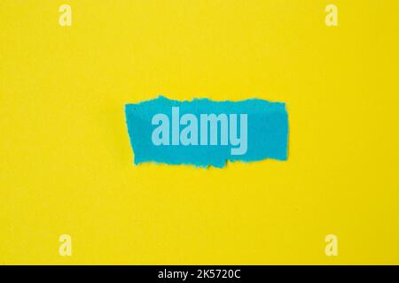 piece of a rectangular blue paper on yellow background Stock Photo