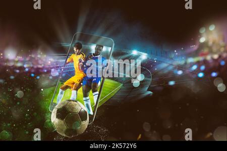 Watch a live sports event on your mobile device. Betting on football matches Stock Photo