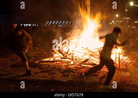 France, Eure, La Haye-de-Routot, traditional bonfire of Saint-Clair, a 15 meters high pyramid of dry wood is erected, on the village square, in front of the church and its thousand-year-old yews. A mass and a blessing precede the burning of the stake, if the cross at the top does not burn, it is a good sign for the 12 months to come, bringing back home a piece of charred wood, called brandon, will protect the house against lightning Stock Photo