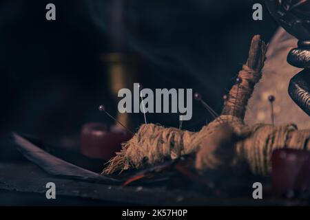 Witchcraft composition with burning candles, jewelry and pentagram symbol. Halloween and occult concept, black magic ritual. Stock Photo