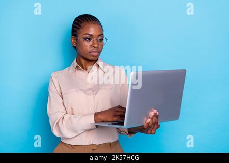 Photo of beautiful skilled business lady searching information in netbook device isolated on blue color background Stock Photo
