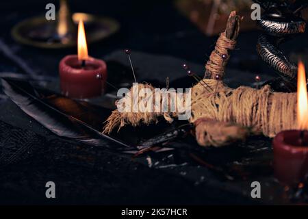 Witchcraft composition with burning candles, jewelry and pentagram symbol. Halloween and occult concept, black magic ritual. Stock Photo