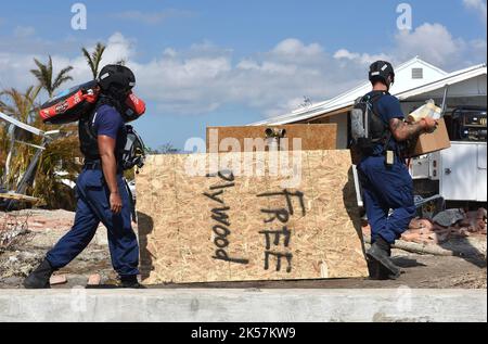 Pine Island, United States. 04th Oct, 2022. Coast Guard Maritime Safety and Security Team Miami crew members carry donated supplies for distribution to residents in the aftermath of Hurricane Ian, October 4, 2022 in Pine Island, Florida. Credit: PO2 Brandon Hillard/US Coast Guard/Alamy Live News Stock Photo