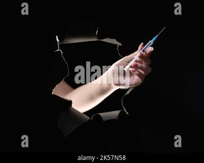 drug dose antibiotic injection hand syringe black Stock Photo