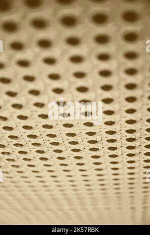 Vertical beige perforated surface of audio textile material. Abstract backgrounds and textures Stock Photo