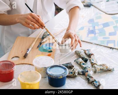 art hobby painting supplies hands mixing paint Stock Photo